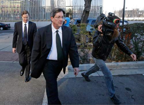 FILE - In this Wednesday, Jan. 21, 2015 file photo, brothers of polygamous sect leader Warren Jeffs, Lyle, foreground, and Nephi, leave the federal courthouse in Salt Lake City. Though Warren Jeffs been in jail in Utah or Texas continually since 2006, he is believed to still rule the Fundamentalist Church of Jesus Christ of Latter-Day Saints through letters and phone calls from prison. Lyle Jeffs makes sure Jeffs' commandments are carried out. To his followers, roughly estimated to be about 6,000, he is a prophet who speaks for God and can do no wrong. (AP Photo/Rick Bowmer)