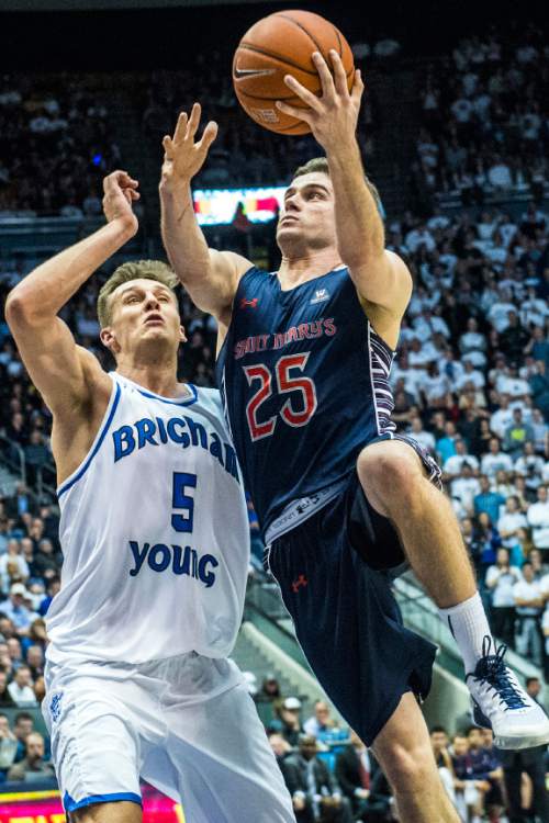 Chris Detrick  |  The Salt Lake Tribune
St. Mary's Gaels guard Joe Rahon (25) shoots past Brigham Young Cougars guard Kyle Collinsworth (5) during the game at the Marriott Center Thursday February 4, 2016.