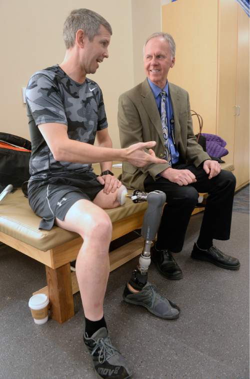 Al Hartmann  |  The Salt Lake Tribune
VA patient Ed Salau talks with Laurence Meyer, MD, PHD Assoc. Chief of Staff Research and Development during a break in a walking session on his new prosthetic limb Wednesday Feb 24 in the physical therapy center at the Salt Lake Veterans Adminsitration Hospital.  For the first time since undergoing surgeries for their Percutaneous Osseointegrated Prosthesis (POP) implant, he and fellow military veteran Bryant Jacobs are walking on their residual limb as part of a Department of Veterans Affairs (VA) and FDA approved Early Feasibility Study (EFS) for above the knee amputees.  After 17 days using the new device he said that he felt like a little kid learning to walk, but he sees steady improvement.