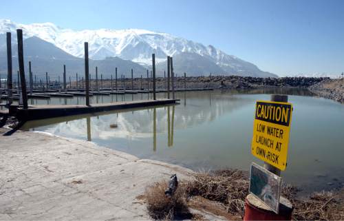 Al Hartmann  |  The Salt Lake Tribune
Signs of the Great Salt Lake's low water level is evident at the Great Salt Lake Marina State Park Thursday Feb 25.  Sailboats were lifted by crane from the harbor and placed in the parking lot last Spring where they remain today. The sailboat harbor is empty with signs warning of low water levels and to launch at your own risk.  The lake has been steadily falling since 2012.