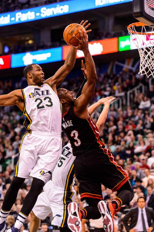 Trent Nelson  |  The Salt Lake Tribune
Miami Heat guard Dwyane Wade (3) puts up a shot, only to be blocked by Utah Jazz forward Chris Johnson (23) as the Utah Jazz host the Miami Heat, NBA basketball in Salt Lake City, Saturday January 9, 2016. Utah Jazz center Jeff Withey (24) at rear.