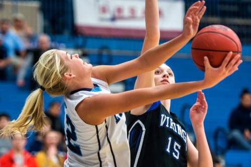 Chris Detrick  |  The Salt Lake Tribune
Layton's Hailey Bassett (12) and Pleasant Grove's Malli Valgardson (15) go for the ball during the 5A girls' basketball quarterfinals at Salt Lake Community College Thursday February 25, 2016. Layton won the game 54-37.