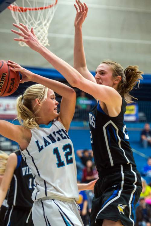 Chris Detrick  |  The Salt Lake Tribune
Layton's Hailey Bassett (12) is fouled by Pleasant Grove's Sara Hamson (22) during the 5A girls' basketball quarterfinals at Salt Lake Community College Thursday February 25, 2016. Layton won the game 54-37.