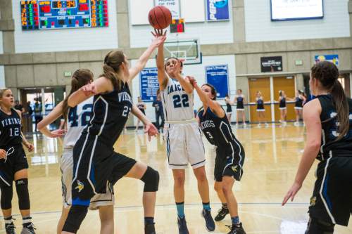 Chris Detrick  |  The Salt Lake Tribune
Layton's Livia Borges (22) shoots past Pleasant Grove's Sara Hamson (22) and Pleasant Grove's Mekenzey Miles (3) during the 5A girls' basketball quarterfinals at Salt Lake Community College Thursday February 25, 2016. Layton won the game 54-37.