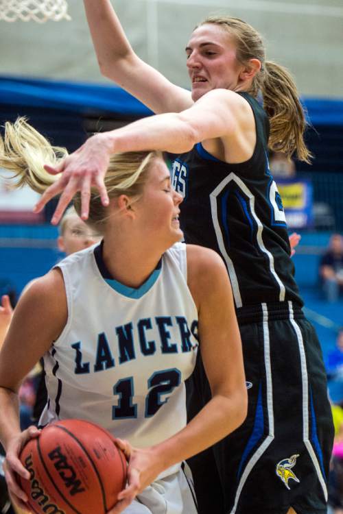 Chris Detrick  |  The Salt Lake Tribune
Layton's Hailey Bassett (12) is fouled by Pleasant Grove's Sara Hamson (22) during the 5A girls' basketball quarterfinals at Salt Lake Community College Thursday February 25, 2016. Layton won the game 54-37.