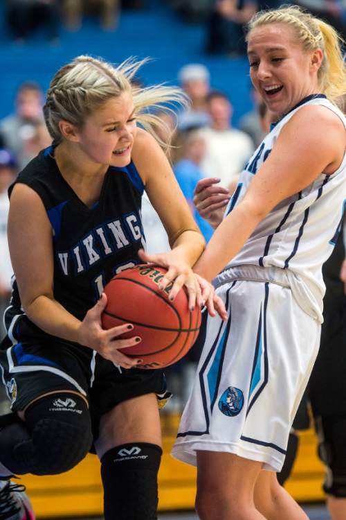 Chris Detrick  |  The Salt Lake Tribune
Pleasant Grove's Faith Williams (12) and Layton's Clara Wood (21) go for the ball during the 5A girls' basketball quarterfinals at Salt Lake Community College Thursday February 25, 2016. Layton won the game 54-37.