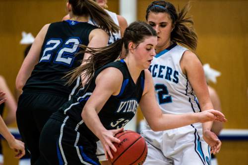 Chris Detrick  |  The Salt Lake Tribune
Pleasant Grove's Sadie Nixon (33) runs around Layton's Livia Borges (22) during the 5A girls' basketball quarterfinals at Salt Lake Community College Thursday February 25, 2016. Layton won the game 54-37.