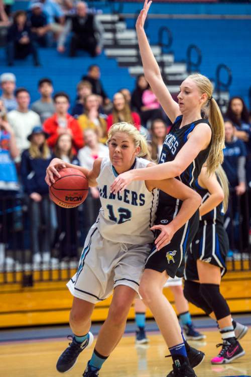 Chris Detrick  |  The Salt Lake Tribune
Layton's Hailey Bassett (12) runs around Pleasant Grove's Malli Valgardson (15) during the 5A girls' basketball quarterfinals at Salt Lake Community College Thursday February 25, 2016. Layton won the game 54-37.