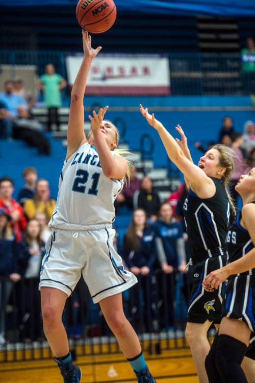 Chris Detrick  |  The Salt Lake Tribune
Layton's Clara Wood (21) shoots past Pleasant Grove's Madison Wilde (4) and Pleasant Grove's Faith Williams (12) during the 5A girls' basketball quarterfinals at Salt Lake Community College Thursday February 25, 2016. Layton won the game 54-37.