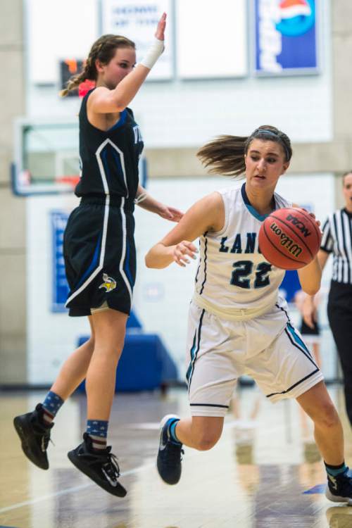 Chris Detrick  |  The Salt Lake Tribune
Layton's Livia Borges (22) runs around Pleasant Grove's Mekenzey Miles (3) during the 5A girls' basketball quarterfinals at Salt Lake Community College Thursday February 25, 2016. Layton won the game 54-37.