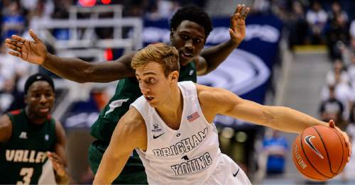 Trent Nelson  |  The Salt Lake Tribune
Brigham Young Cougars guard Chase Fischer (1) dribbles  the ball past Mississippi Valley State Delta Devils forward Vacha Vaughn (0) as BYU hosts Mississippi Valley State, NCAA basketball at the Marriott Center in Provo, Wednesday November 25, 2015.