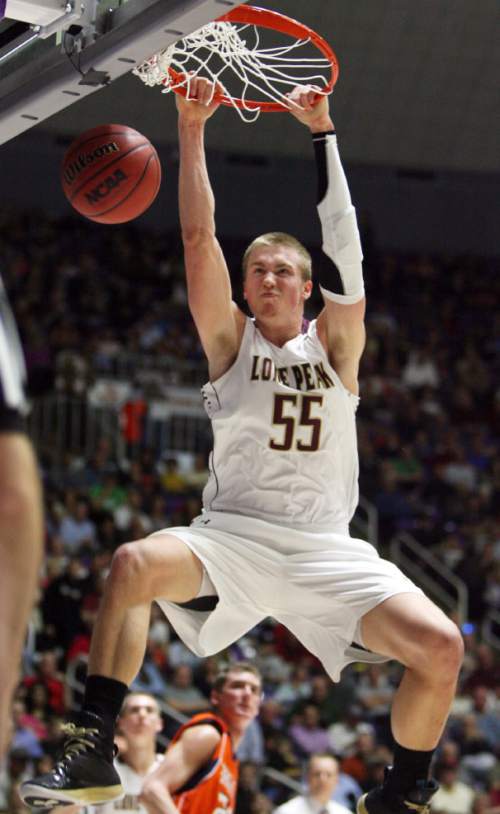 Kim Raff  |  The Salt Lake Tribune
Lone Peak's Eric Mika dunks the ball during the 5A state semifinal game against Brighton at the Dee Event Center in Ogden on March 1, 2013. Lone Peak went on to win the game 53-27.