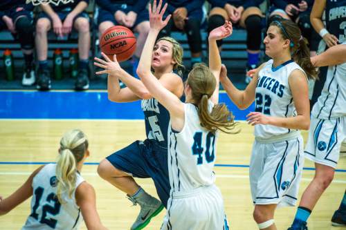Chris Detrick  |  The Salt Lake Tribune
Copper Hills's Shirsten Wissinger (35) shoots past Layton's Olivia James (40) during the 5A girls' basketball semifinals at Salt Lake Community College Friday February 26, 2016. Layton defeated Copper Hills 46-44 in overtime.