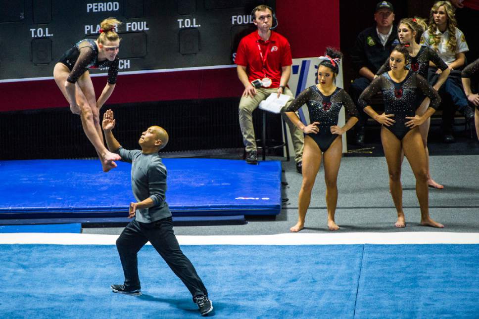 Chris Detrick  |  The Salt Lake Tribune
Co-Head Coach Tom Farden helps Utah gymnast MaKenna Merrell performs her floor routine during the Red Rocks Preview at the Huntsman Center Friday December 11, 2015.