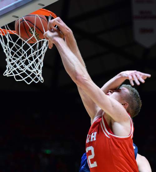 Steve Griffin  |  The Salt Lake Tribune

Utah Utes forward Jakob Poeltl (42) gets smacked across the face by Brigham Young Cougars forward Kyle Davis (21) as he slams home two during first half action in the Utah versus BYU men's basketball game at the Huntsman Center in Salt Lake City, Wednesday, December 2, 2015.