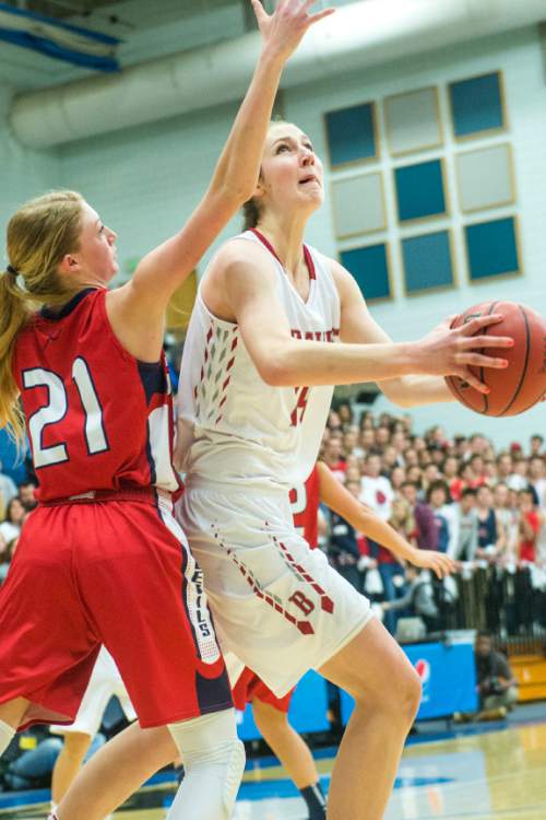 Chris Detrick  |  The Salt Lake Tribune
Bountiful's Kennedy Redding (24) shoots past Springville's Cheyanne Brown (21) during the 4A girls' basketball championships at Salt Lake Community College Saturday February 27, 2016. Bountiful defeated Springville 63-42.