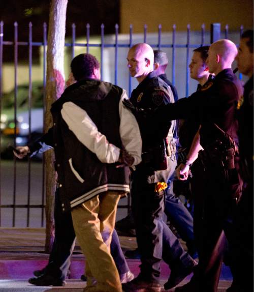 Lennie Mahler  |  The Salt Lake Tribune

Police arrest a man in an angry crowd that formed after an officer-involved shooting at 200 South Rio Grande Street in Salt Lake City, Saturday, Feb. 27, 2016.