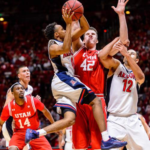 Trent Nelson  |  The Salt Lake Tribune
Arizona Wildcats guard Parker Jackson-Cartwright (0) runs into Utah Utes forward Jakob Poeltl (42) while driving to the basket as Utah hosts Arizona, NCAA basketball at the Huntsman Center in Salt Lake City, Saturday February 27, 2016. At right is Arizona Wildcats forward Ryan Anderson (12).