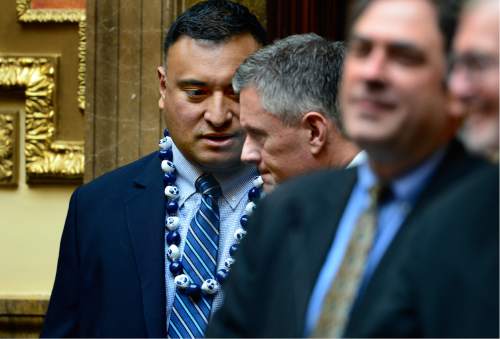 Scott Sommerdorf   |  The Salt Lake Tribune  
BYU head football coach Kelani Sitake, left, leans in to speak to Utah head coach Kyle Whittingham as they both visited the Utah House of Representatives, Thursday, March 3, 2016. They were later both honored for their football accomplishments by an introduction on the floor.