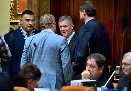 Scott Sommerdorf   |  The Salt Lake Tribune  
BYU head football coach Kelani Sitake, left, and Utah head coach Kyle Whittingham speak with legislators as they both visited the Utah House of Representatives, Thursday, March 3, 2016. They were later both honored for their football accomplishments by an introduction on the floor.