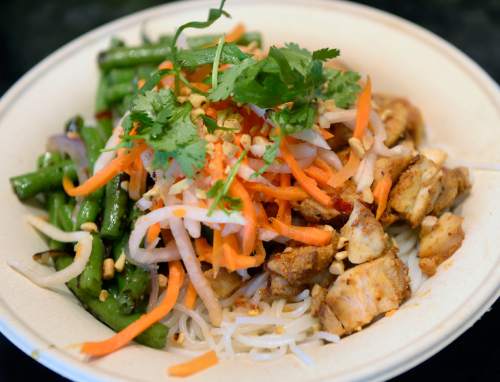 Al Hartmann  |  The Salt Lake Tribune
Zao Asian Cafe's rice noodle bowl made with chicken, seared vegetables, garnishes and choice of sweet soy, green curry or chili lemongrass sauce.