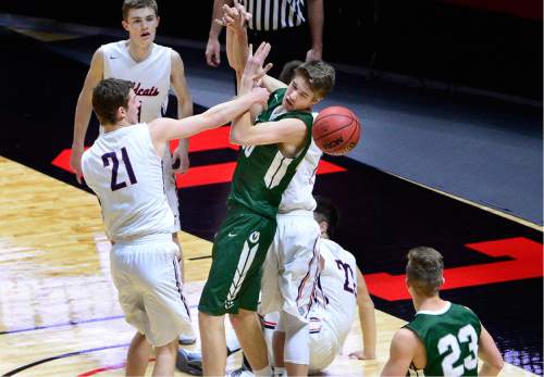 Scott Sommerdorf   |  The Salt Lake Tribune  
Trevan Knell punches the ball loose from Olympus F Isaac Monson during first half play. Olympus beat Woods Cross 70-42 in a 4A semi-final played at the University of Utah, Friday, March 4, 2016.