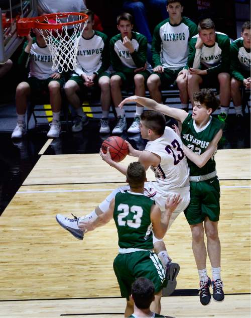 Scott Sommerdorf   |  The Salt Lake Tribune  
Olympus G Jeremy Dowdell tries to block the layup by Woods Cross G Jordan Lewis during first half play. Olympus held a 37-28 lead over Woods Cross at the half in a 4A semi-final played at the University of Utah, Friday, March 4, 2016.