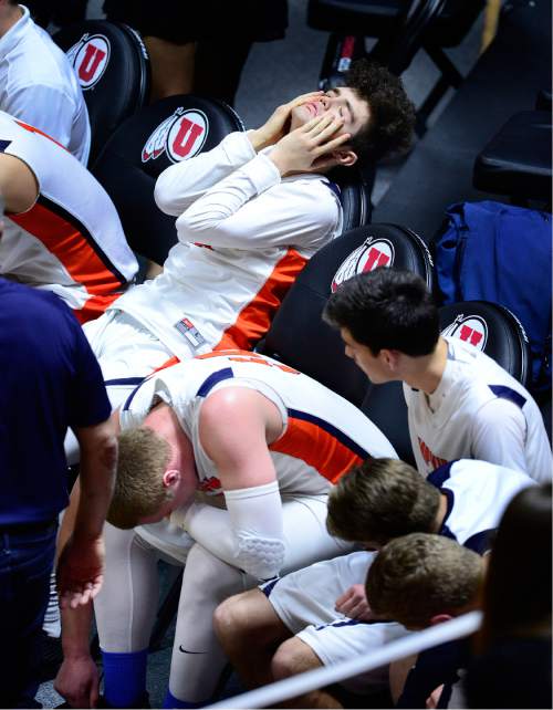 Scott Sommerdorf   |  The Salt Lake Tribune  
Timpview's Adam Santiago reacts as his team mate AJ Bollinger (below) is doubled over in pain with an ankle injury. Bollinger was able to come back and anchored the team as Timpview beat Highland 59-49 in a 4A semi-final played at the University of Utah, Friday, March 4, 2016.