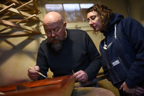Francisco Kjolseth  |  The Salt Lake Tribune
Scott Gardner, a master art framer who started his training in England some 37-years ago teaches apprentice Adrienne C.B. Winter the proper technique for creating a faux wood grain finish on a frame.