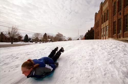 A sledder slides past the old Bingham High in Copperton in January of 2001. The school was torn down in 2002. Tribune file photo by Danny La.