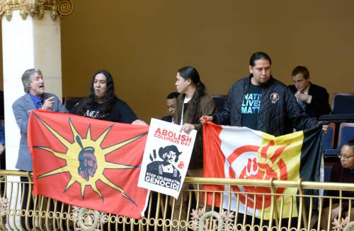 Leah Hogsten  |  The Salt Lake Tribune
Three men from the Navajo Nation unfurled flags and handmade banners in the Senate gallery, March 7, 2016 and began demanding to speak with Sen. Todd Weiler, R-Woods Cross, for his remarks during floor debate over a proposal to rename Columbus Day as Indigenous Peoples Day that was killed last week. During debate, Sen. Weiler, said "The native population gave the early explorers syphilis, which they brought back to Europe. Blaming Columbus for the extermination of the native population is as fair as blaming the native population for people who die using tobacco and cocaine, which the natives introduced to the Europeans."