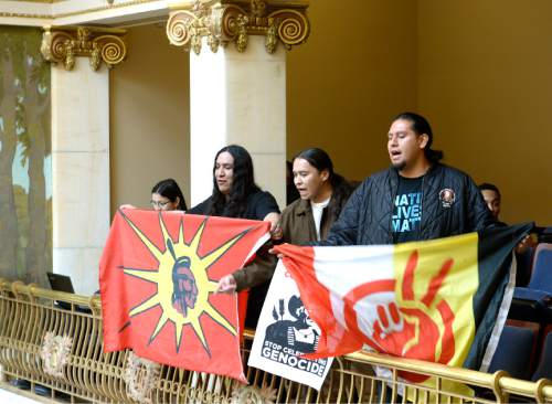 Leah Hogsten  |  The Salt Lake Tribune
Three men from the Navajo Nation unfurled flags and handmade banners in the Senate gallery, March 7, 2016 and began demanding to speak with Sen. Todd Weiler, R-Woods Cross, for his remarks during floor debate over a proposal to rename Columbus Day as Indigenous Peoples Day that was killed last week. During debate, Sen. Weiler, said "The native population gave the early explorers syphilis, which they brought back to Europe. Blaming Columbus for the extermination of the native population is as fair as blaming the native population for people who die using tobacco and cocaine, which the natives introduced to the Europeans."