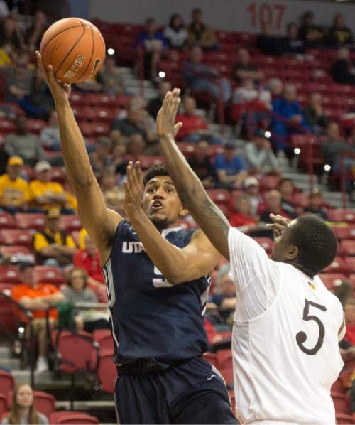 Rick Egan  |  The Salt Lake Tribune

Utah State Aggies guard Julion Pearre (5) drives to the basket, as Wyoming Cowboys forward Alan Herndon (5) defends, in the Mountain West Conference playoff action, at the Thomas & Mack Center, in Las Vegas, Wednesday, March 8, 2016.