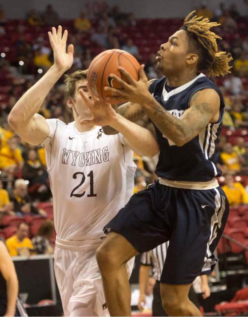 Rick Egan  |  The Salt Lake Tribune

Utah State Aggies guard Shane Rector (4) goes in for a shot, as Wyoming Cowboys center Jonathan Barnes (21) defends, in the Mountain West Conference playoff action, at the Thomas & Mack Center, in Las Vegas, Wednesday, March 8, 2016.