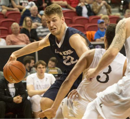 Rick Egan  |  The Salt Lake Tribune

Utah State Aggies forward Quinn Taylor (22) works the ball inside, as Wyoming Cowboys guard Alexander Aka Gorski (3) defends, in the Mountain West Conference playoff action, at the Thomas & Mack Center, in Las Vegas, Wednesday, March 8, 2016.
