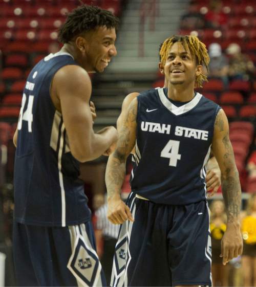 Rick Egan  |  The Salt Lake Tribune

Utah State Aggies guard Shane Rector (4)  and Utah State Aggies guard Chris Smith (34) are all smiles after defeating Wyoming Cowboys 88-70, to advance in  the Mountain West Conference playoffs, at the Thomas & Mack Center, in Las Vegas, Wednesday, March 8, 2016.