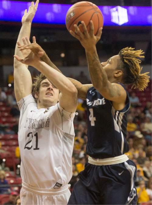 Rick Egan  |  The Salt Lake Tribune

Utah State Aggies guard Shane Rector (4) goes in for a shot, as Wyoming Cowboys center Jonathan Barnes (21) defends, in the Mountain West Conference playoff action, at the Thomas & Mack Center, in Las Vegas, Wednesday, March 8, 2016.