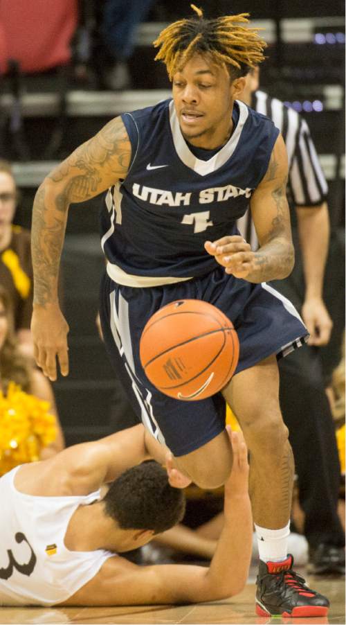 Rick Egan  |  The Salt Lake Tribune

Utah State Aggies guard Shane Rector (4) leads a fast break, after grabbing the ball from Wyoming Cowboys guard Alexander Aka Gorski (3), in the Mountain West Conference playoff action, at the Thomas & Mack Center, in Las Vegas, Wednesday, March 8, 2016.