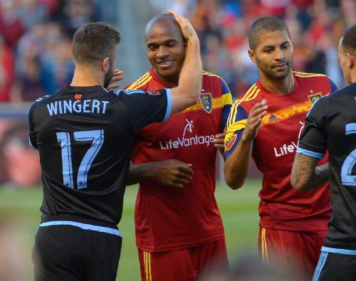 Former Real Salt Lake player and now New York City FC defender Chris Wingert (17) greets Real Salt Lake defender Jamison Olave (4) at an MLS soccer game Saturday, May 23, 2015, in Sandy, Utah. (Leah Hogsten/The Salt Lake Tribune via AP)