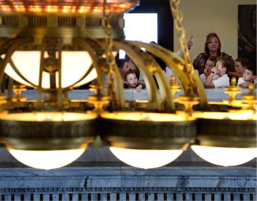 Scott Sommerdorf   |  The Salt Lake Tribune  
Students from the Syracuse Arts Academy get a tour of the Capitol building as they pause near the light fixture that hangs above the rotunda, Thursday, March 10, 2016.