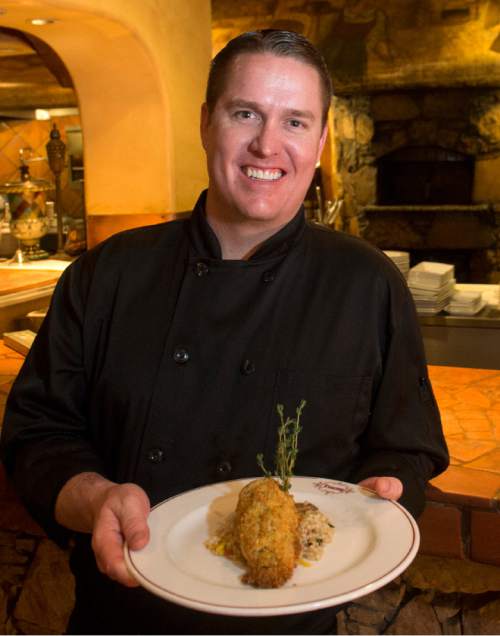 Rick Egan  |  The Salt Lake Tribune

Adam Vickers, the chef at Tuscany, holds a plate of pecan encrusted salmon. Former Utah Jazz Center Mark Eaton, and the rest of his team at Tuscany, will be celebrating the 20th anniversary of the restaurant on Saturday, March 11. On that day Tuscany willbe  rolling out 1996 menu items and 1996 prices.