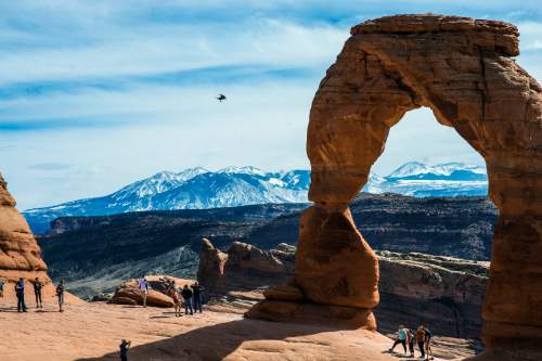 Chris Detrick  |  The Salt Lake Tribune
Visitors take pictures and hike around Delicate Arch in Arches National Park Saturday March 5, 2016.