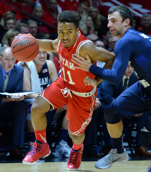 Steve Griffin  |  The Salt Lake Tribune

Utah Utes guard Brandon Taylor (11) drives past Brigham Young Cougars guard Nick Emery (4) during first half action in the Utah versus BYU men's basketball game at the Huntsman Center in Salt Lake City, Wednesday, December 2, 2015.