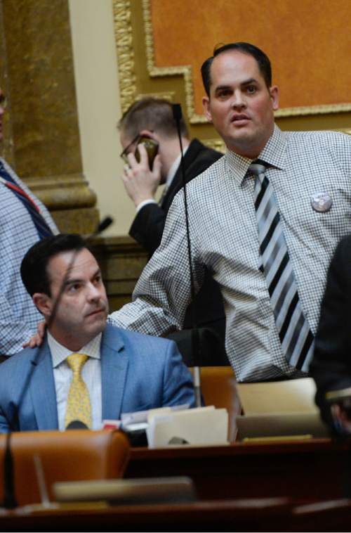 Francisco Kjolseth | The Salt Lake Tribune
Representatives Brad Wilson, R-Kaysville, left, is joined by Mike McKell, R-Spanish Fork, as he watches the board while the House passed SB246, that would use sales-tax revenue to help acquire a coal port in California onThursday, March 10, 2016.