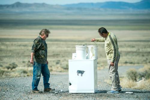 Chris Detrick  |  The Salt Lake Tribune
Robert Kirby and friend Sonny inspect the damage after they fired a pool ball out of a cannon into paint buckets in Rush Valley Saturday March 21, 2015.