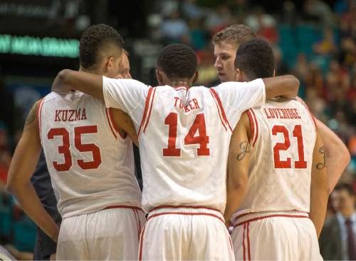 Rick Egan  |  The Salt Lake Tribune

Utah Utes forward Kyle Kuzma (35) Dakarai Tucker (14) and Jordan Loveridge (21) huddle together during a break in the action, in PAC-12 Basketball Championship action, as Utah defeated USC Trojans 80-72, at the MGM Arena, in Las Vegas, Thursday, March 10, 2016.