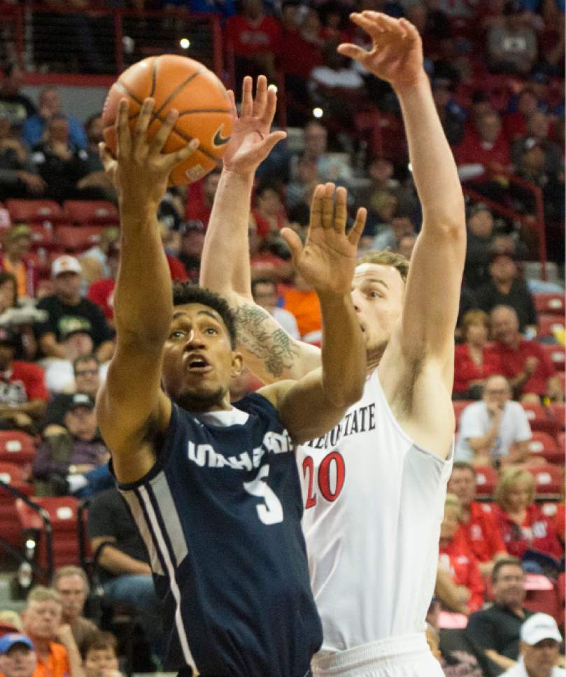 Rick Egan  |  The Salt Lake Tribune

Utah State Aggies guard Julion Pearre (5) goes to the hoop, as San Diego State Aztecs forward Matt Shrigley (20) defends, in Mountain West Tournament action, The Utah State Aggies vs. San Diego State Aztecs, at the Thomas and Mack Center in Las Vegas, Thursday, March 10, 2016.