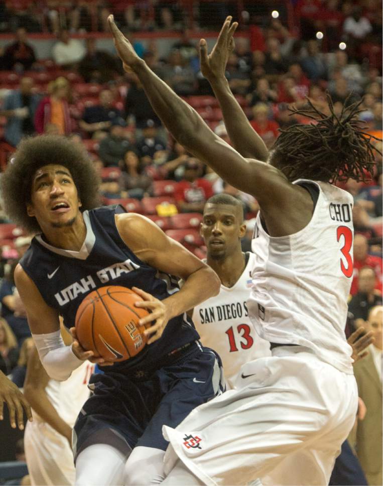 Rick Egan  |  The Salt Lake Tribune

Utah State Aggies forward Jalen Moore (14) looks for a shot, as San Diego State Aztecs forward Angelo Chol (3) defends, in Mountain West Tournament action, The Utah State Aggies vs. San Diego State Aztecs, at the Thomas and Mack Center in Las Vegas, Thursday, March 10, 2016.
