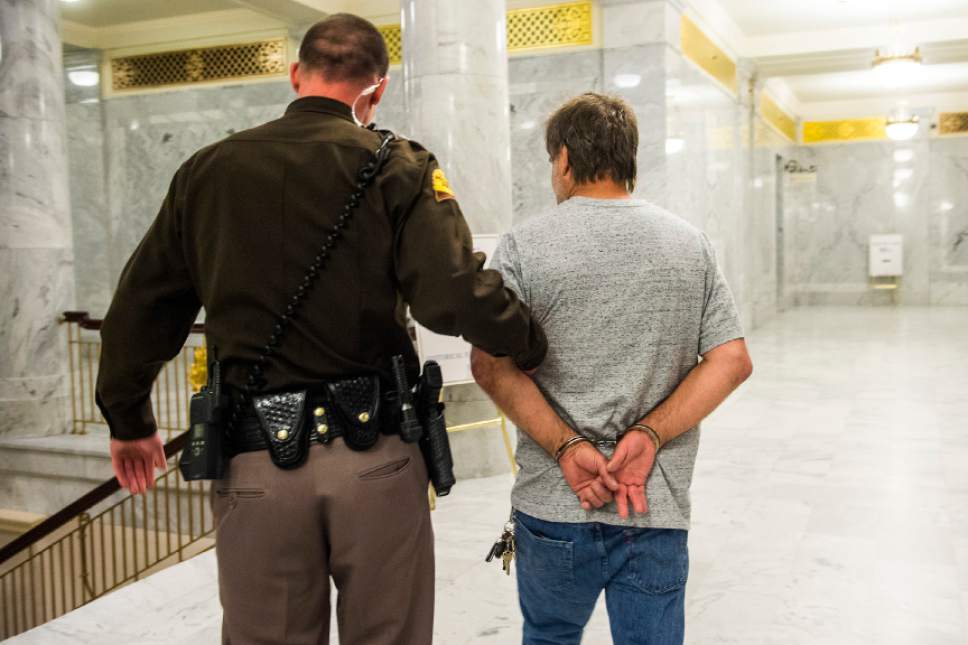 Chris Detrick  |  The Salt Lake Tribune
Randy Gardner is escorted out by members of the Utah Highway Patrol at the Utah State Capitol on Thursday, March 10, 2016. Gardner's brother Ronnie Lee Gardner was executed by firing squad in Utah in 2010.