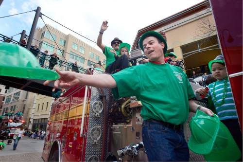 Scott Sommerdorf   |  The Salt Lake Tribune  
Green fireman hats were tossed from a firetruck at the 40th annual St. Patrick's Day organized by the Hibernian Society of Utah, Saturday, March 12, 2016.